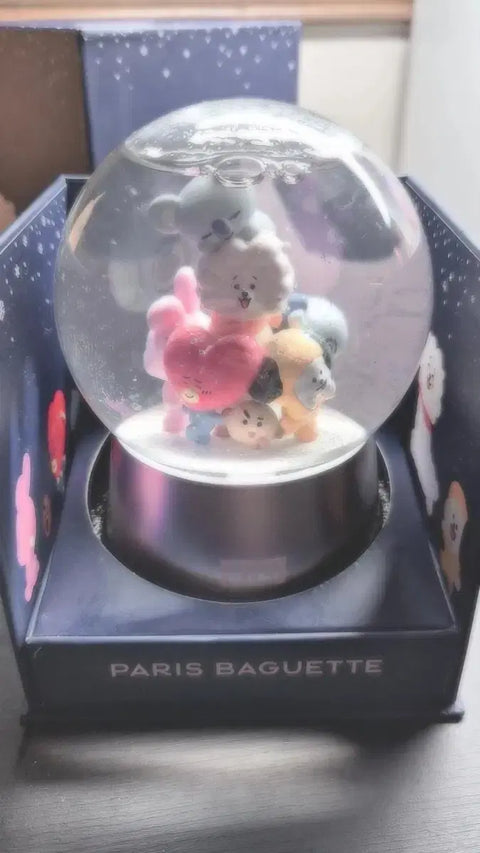 Selling BT21 snow globes.